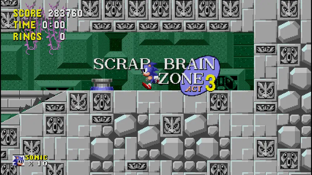 Sonic llega a Scrap Brain Zone Act 3, rodeado de paredes de piedra con relieves metálicos y un fondo verde oscuro.