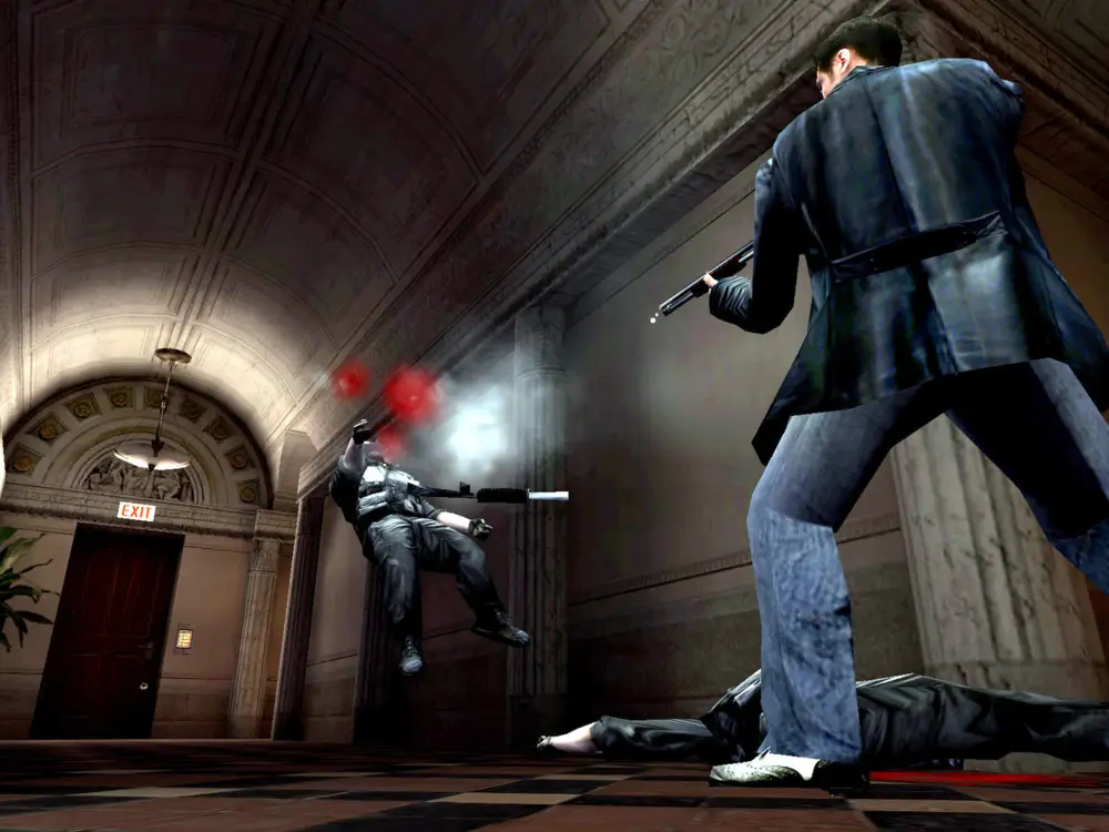 Max Payne dispara con una escopeta a un enemigo en un elegante pasillo, mientras otro cuerpo yace en el suelo.