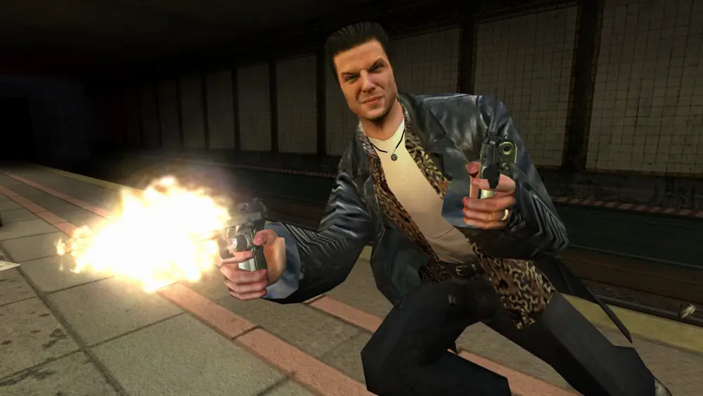 Max Payne, el protagonista del videojuego, disparando dos pistolas mientras se inclina en una estación de metro, con un gesto intenso en el rostro.